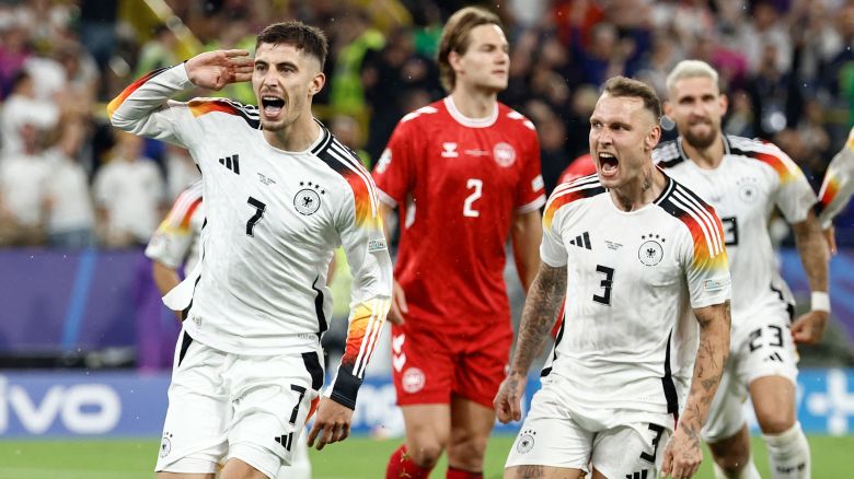 Kai Havertz (left) celebrates after scoring Germany's first goal from the penalty spot against Denmark at Euro 2024.