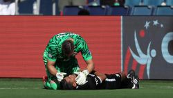 KANSAS CITY, KANSAS - JUNE 25: Maxime Crepeau of Canada aids assistant referee Humberto Panjoj during the CONMEBOL Copa America 2024 between Peru and Canada at Children's Mercy Park on June 25, 2024 in Kansas City, Kansas. (Photo by Jamie Squire/Getty Images)