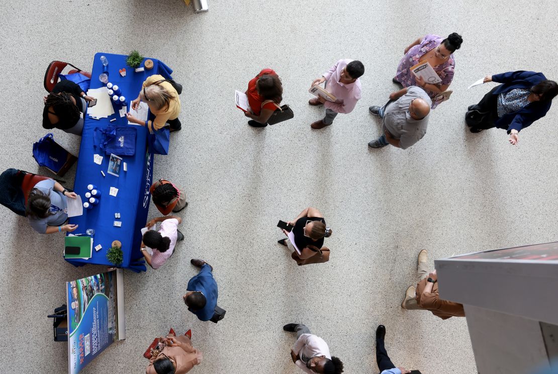 Job seekers attends a South Florida job fair on June 26, 2024. Economists say the challenging jobs market, and the risks around AI, put the onus on college students to choose where they focus wisely.