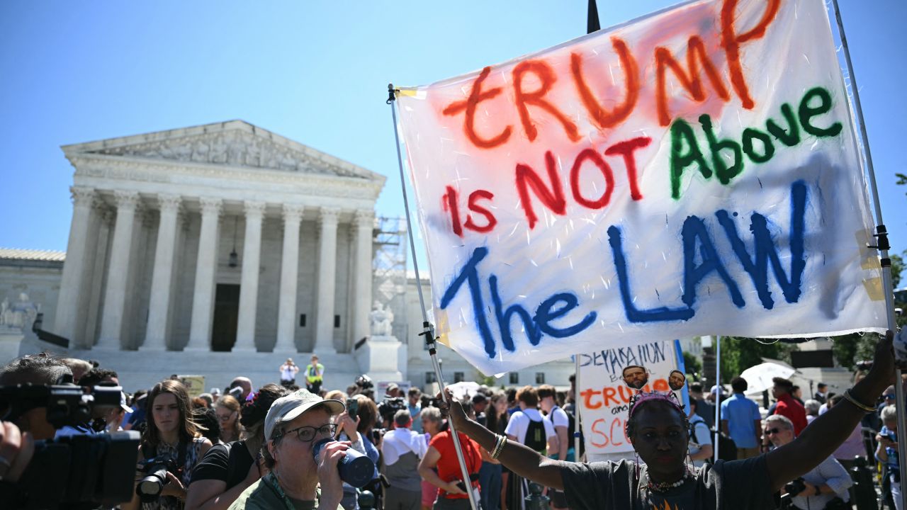 TOPSHOT - People hold anti Trump signs in front of the US Supreme Court on July 1, 2024, in Washington, DC. Donald Trump on Monday hailed a "big win" for democracy after the US Supreme Court ruled that presidents have presumptive immunity for official acts -- a decision set to delay his trial for conspiring to overturn his 2020 election loss. (Photo by Drew ANGERER / AFP) (Photo by DREW ANGERER/AFP via Getty Images)