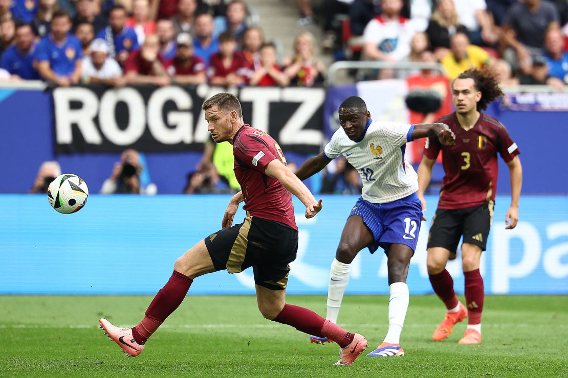 Kolo Muani's shot at the Belgium goal is deflected in by Vertonghen (left).