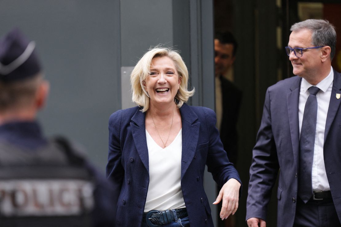 Former president of the French far-right National Rally, or Rassemblement National (RN) parliamentary group Marine Le Pen and RN Mayor of Perpignan Louis Aliot leave the party's headquarters in Paris on July 2, 2024.