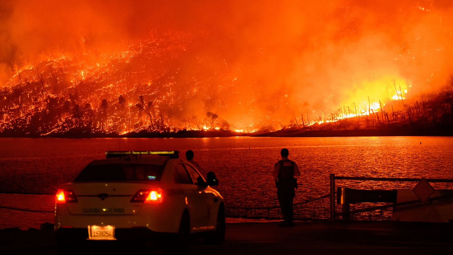 The Thompson fire burns over Lake Oroville, California on July 2, 2024. A heatwave sent temperatures soaring resulting in red flag fire warnings throughout the state.