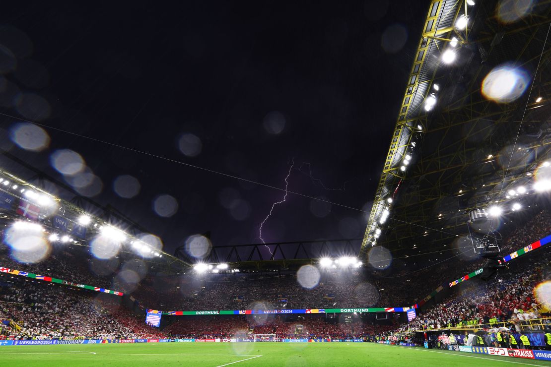 Lightning is seen inside the stadium during the enforced break.