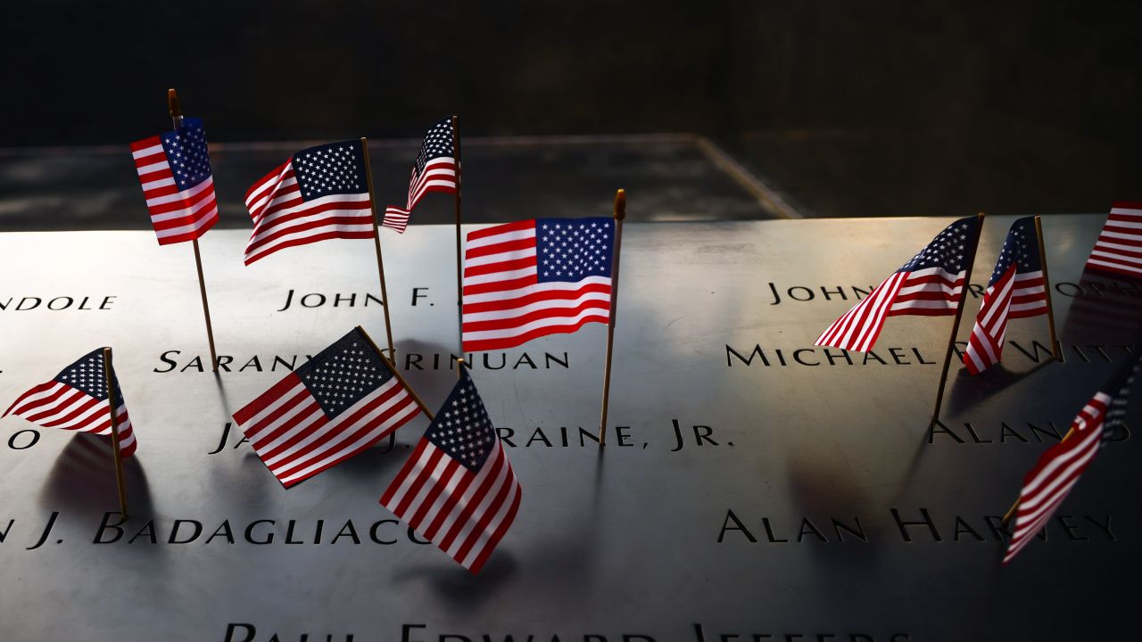 U.S. flags are placed on the names of victims at the South Tower Memorial Pool at the National 9/11 Memorial on Independence Day In New York, United States on America on July 4th, 2024. (Photo by Beata Zawrzel/NurPhoto via Getty Images)