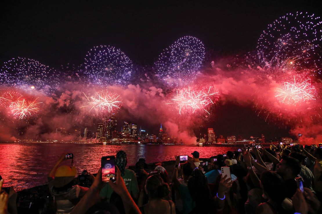 People gather near the Hudson River during the annual Macy's Independence Day fireworks show as seen from Hoboken, New Jersey, on July 4, 2024.