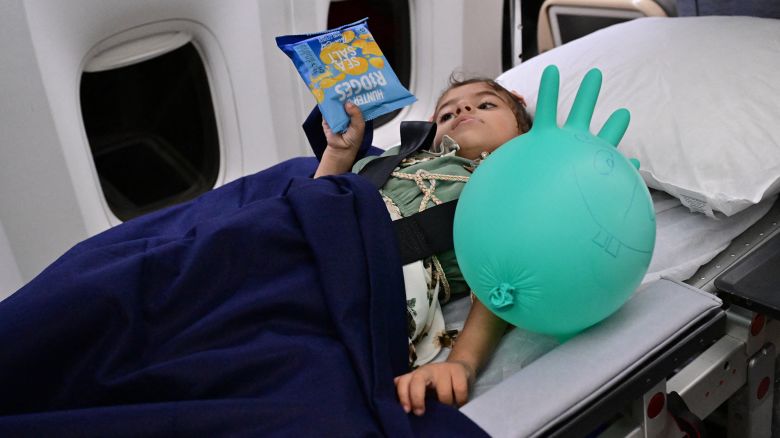 An injured Palestinian child evacuated from the Gaza Strip, lies inside an Emirati aircraft transferring her from Egypt to get treatment in the UAE on July 5, 2024. (Photo by Giuseppe CACACE / AFP) (Photo by GIUSEPPE CACACE/AFP via Getty Images)