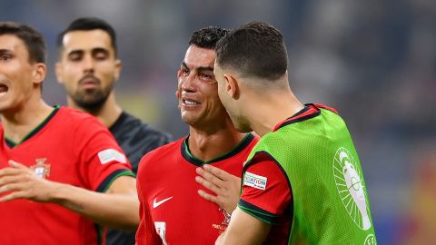 FRANKFURT AM MAIN, GERMANY - JULY 01: Cristiano Ronaldo of Portugal looks dejected as he is consoled by teammates ahead of the second half of extra-time during the UEFA EURO 2024 round of 16 match between Portugal and Slovenia at Frankfurt Arena on July 01, 2024 in Frankfurt am Main, Germany. (Photo by Justin Setterfield/Getty Images)