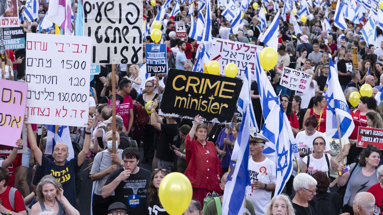 TEL AVIV, ISRAEL - JULY 6: Protesters hold signs during a demonstration calling for an hostages deal and against the  Israeli Prime Minister Benjamin Netanyahu and his government  on July 6, 2024 in Tel Aviv, Israel. Anti-government protesters filled Tel Aviv today in their weekly protests calling for a hostage deal and new elections. This weeks rally is dedicated to the mothers of hostages and will see the start of a "week of resistance," with Sunday, July 7 marking nine months since the October 7 attacks and the start of the Israel-Hamas war. (Photo by Amir Levy/Getty Images)