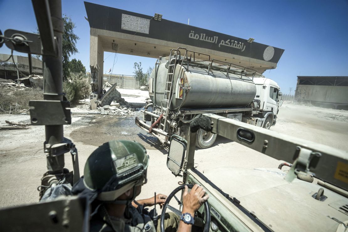 Israeli soldiers drive on the Palestinian side of Kerem Shalom crossing during a ground operation on July 3. The Israeli military invited reporters for a tour of Rafah, where the military has been operating since May 6.