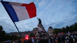 A participant waves a French national tricolor during an election night rally following the first results of the second round of France's legislative election at Place de la Republique in Paris on July 7, 2024. A loose alliance of French left-wing parties thrown together for snap elections was on course to become the biggest parliamentary bloc and beat the far right, according to shock projected results. (Photo by Emmanuel Dunand / AFP) (Photo by EMMANUEL DUNAND/AFP via Getty Images)
