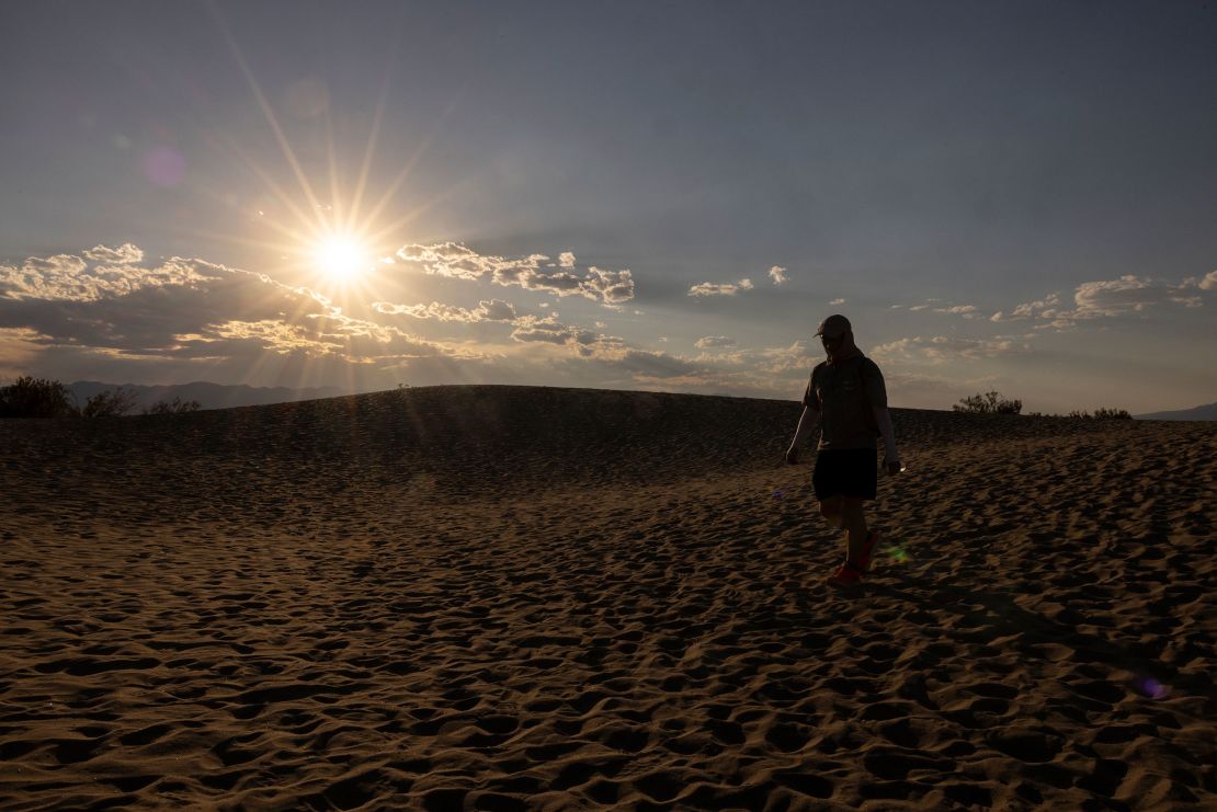 A tourist hikes in the Mesquite Flat Sand Dunes in Death Valley National Park, near Furnace Creek, during a heatwave impacting Southern California on July 7, 2024.