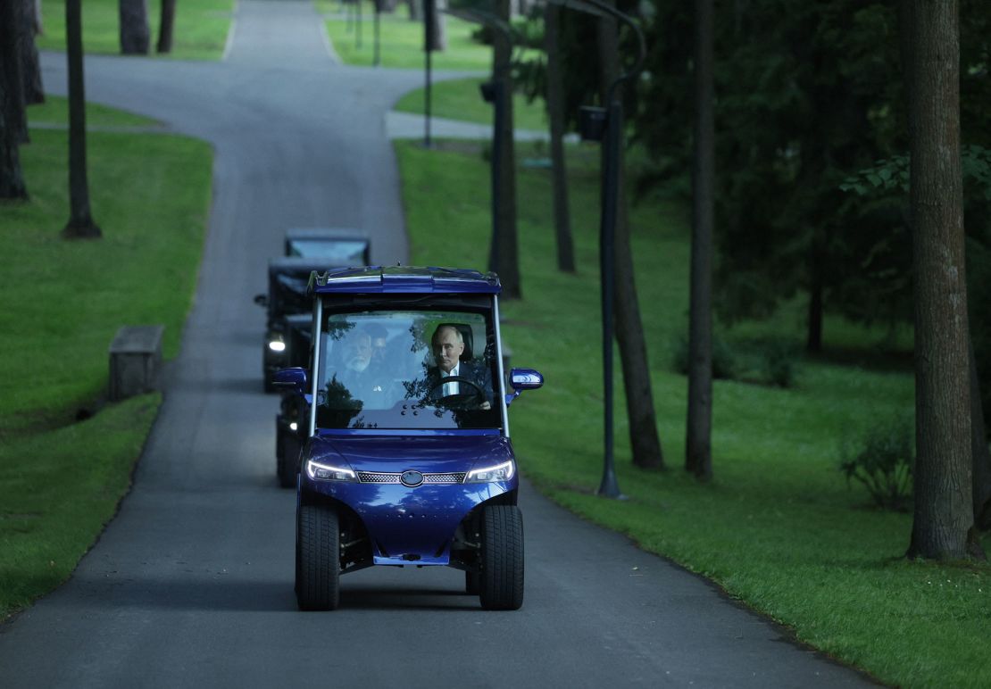 Russian President Vladimir Putin and Indian Prime Minister Narendra Modi ride on a golf cart during an informal meeting at the Novo-Ogaryovo state residence, outside Moscow, on July 8, 2024.