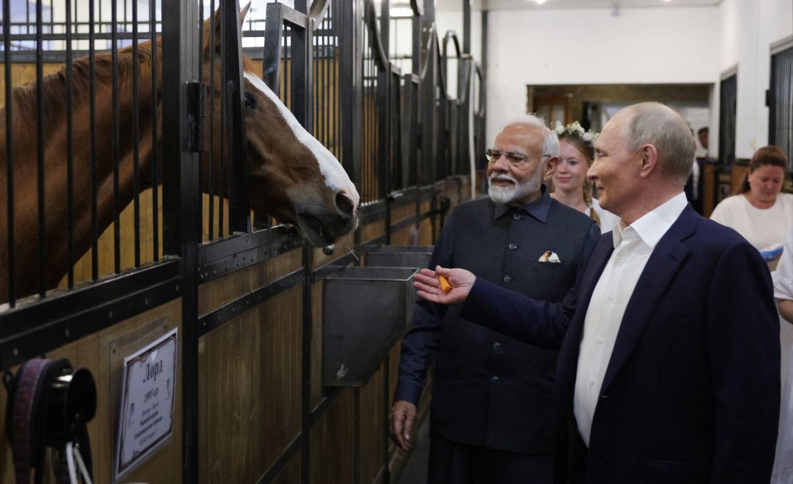 In this pool photograph distributed by the Russian state agency Sputnik, Russia's President Vladimir Putin and Indian Prime Minister Narendra Modi visit the stable during an informal meeting at the Novo-Ogaryovo state residence, outside Moscow, on July 8, 2024. (Photo by Gavriil GRIGOROV / POOL / AFP) (Photo by GAVRIIL GRIGOROV/POOL/AFP via Getty Images)