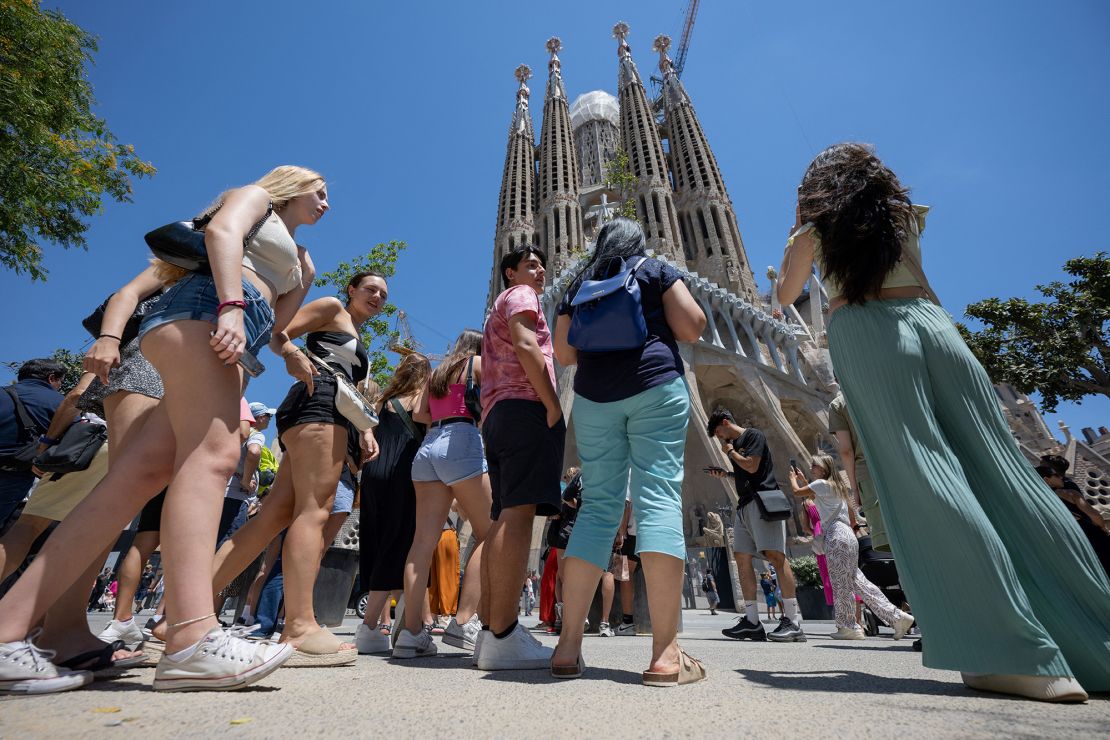 Tourists in front of the Sagrada Familia church in Barcelona, Spain, in July 2024.