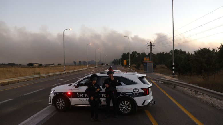 Israeli police secure a road as rockets are launched from southern Lebanon in the Israeli-annexed Golan Heights on July 9, 2024, amid ongoing cross-border clashes between Israeli troops and Hezbollah fighters.