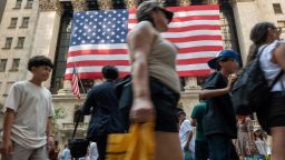 People walk by the New York Stock Exchange New York on July 05, 2024.