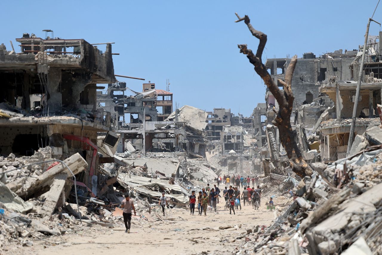 A Palestinian walks through a destroyed building in Gaza on July 11, 2024.