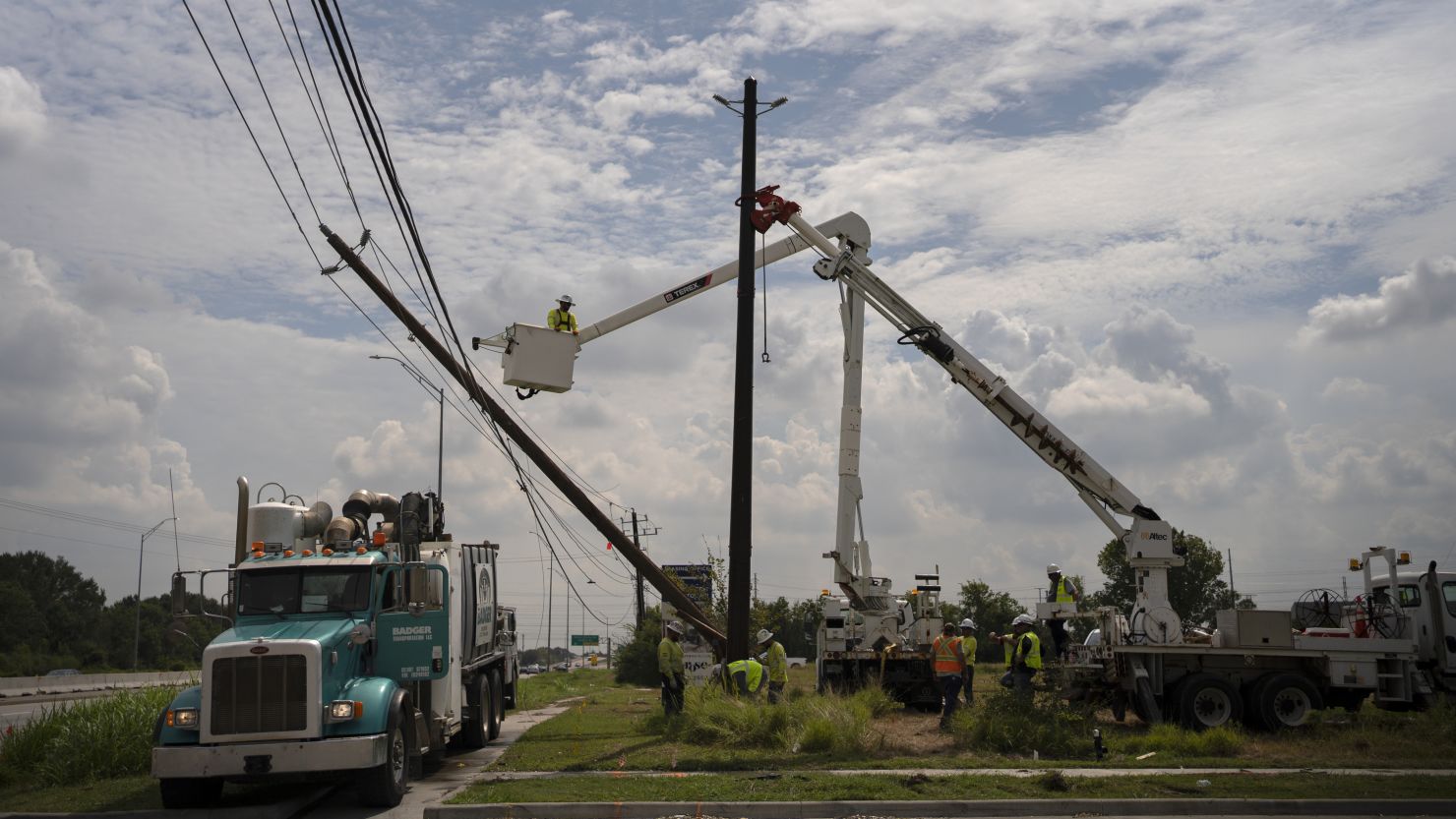 Crews from out of the area help CenterPoint to restore power lines on July 11, 2024, in Houston.