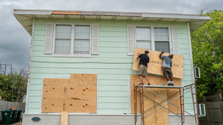 (L-R) Dane Allen and Randy Davis board up apartments ahead of Tropical Storm Beryl's arrival on July 07, 2024 in Corpus Christi, Texas. Tropical Storm Beryl is projected to strengthen into a hurricane by its arrival on Texas shores. The storm is situated southeast of Corpus Christi, Texas, and is projected to intensify with the possibility of rainfall flooding, accelerated winds, and tornados.