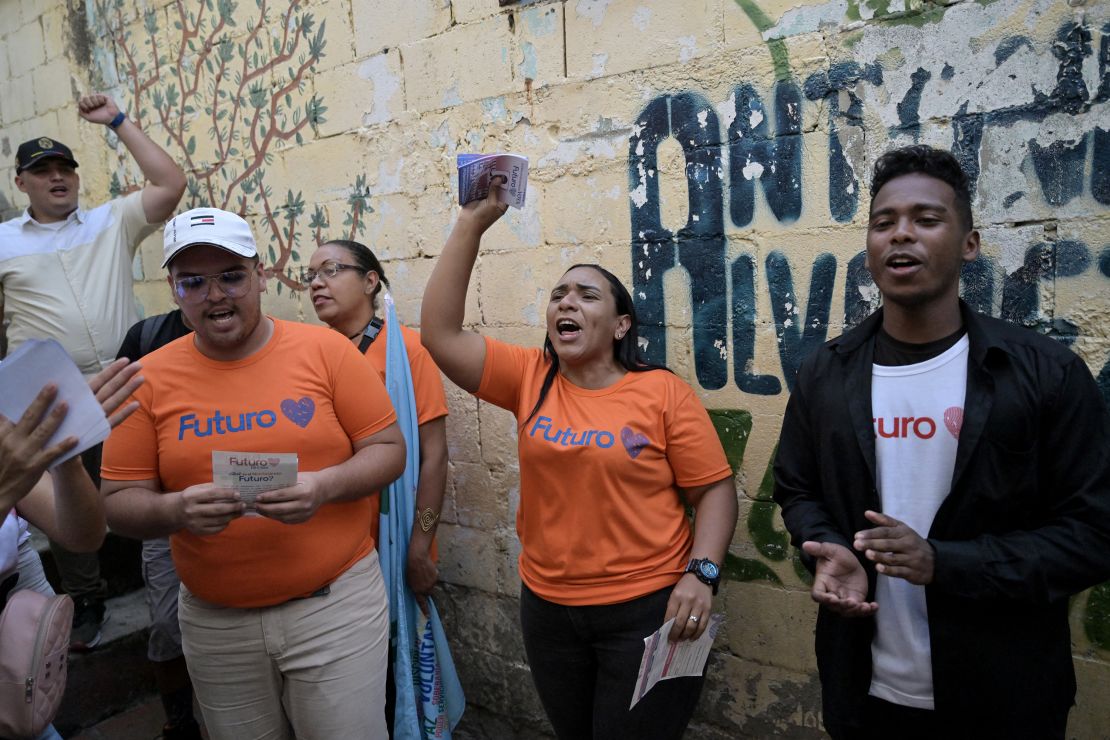 Supporters of Venezuelan President and presidential candidate Nicolas Maduro shout slogans during a flyer distribution in the neighborhood of Agua de Maiz in Caracas on July 11, 2024. Venezuela will hold presidential elections on July 28. (Photo by Juan BARRETO / AFP) (Photo by JUAN BARRETO/AFP via Getty Images)