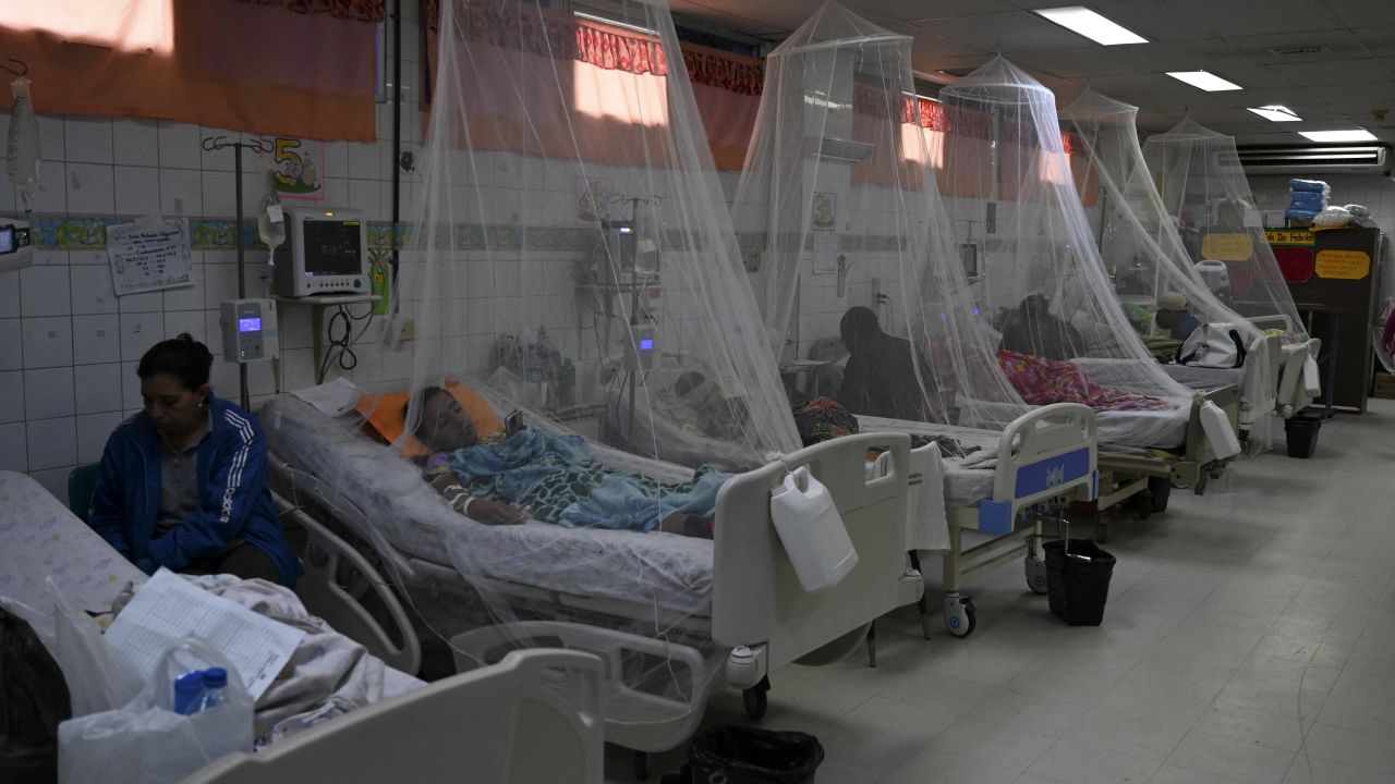 Dengue fever patients rest under a mosquito net at the Hospital Escuela Universitario in Tegucigalpa on July 12, 2024. . An outbreak of dengue fever in Central America has left a hundred dead this year, with Guatemala ing for half of the deaths, health officials reported on Friday. (Photo by Orlando SIERRA / AFP) (Photo by ORLANDO SIERRA/AFP via Getty Images)