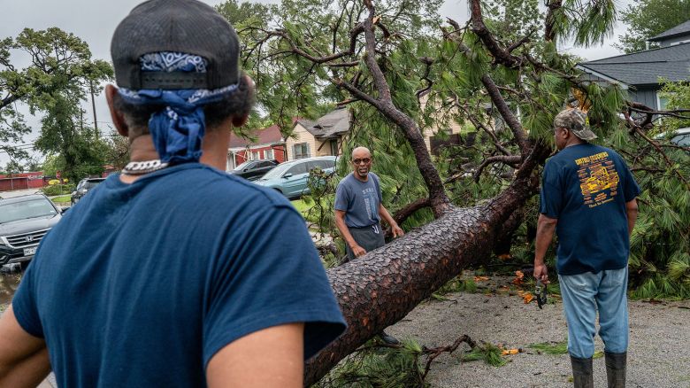 HOUSTON, TEXAS - JULY 08: Residents assess a fallen tree in their in their neighborhood after Hurricane Beryl swept through the area on July 08, 2024 in Houston, Texas. Tropical Storm Beryl developed into a Category 1 hurricane as it hit the Texas coast late last night. (Photo by Brandon Bell/Getty Images)