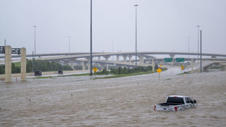 HOUSTON, TEXAS - JULY 08: A vehicle is left abandoned in floodwater on a highway after Hurricane Beryl swept through the area on July 08, 2024 in Houston, Texas. Tropical Storm Beryl developed into a Category 1 hurricane as it hit the Texas coast late last night. (Photo by Brandon Bell/Getty Images)
