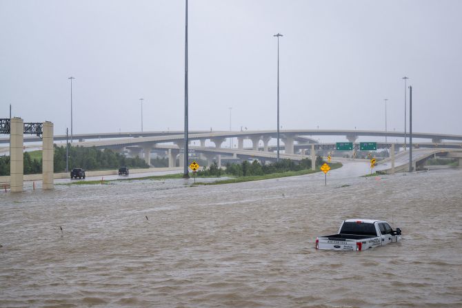 A vehicle is left abandoned Monday on a <a href="https://www.cnn.com/weather/live-news/hurricane-beryl-texas-07-08-24#h_e15398f1e28ea31abaf5d87f8b553ba9">flooded highway</a> in Houston.