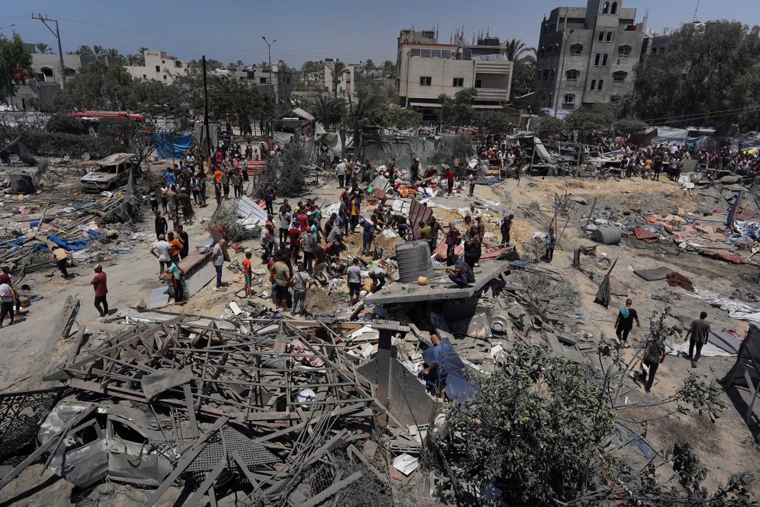 Palestinians look at the debris of destroyed tents and makeshift housing structures following the Israeli strike on the Al-Mawasi camp on July 13. The IDF says this attack killed Mohammed Deif.