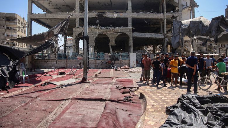 Palestinians gather at the site of an Israeli strike which hit a makeshift prayer hall at Al Shati refugee camp west of Gaza City on July 13, 2024.