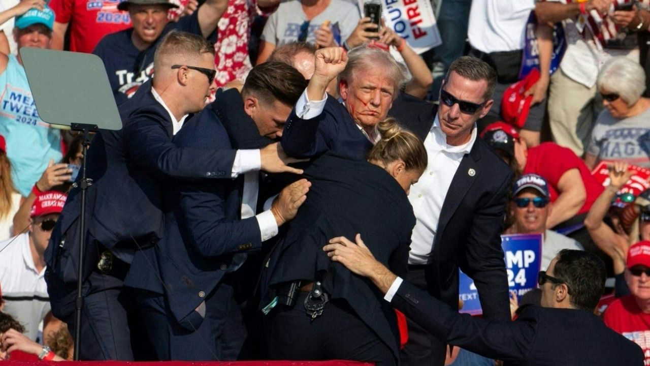 Republican candidate Donald Trump is seen with blood on his face surrounded by secret service agents as he is taken off the stage at a campaign event at Butler Farm Show Inc. in Butler, Pennsylvania, July 13, 2024. Republican candidate Donald Trump was evacuated from the stage at today's rally after what sounded like shots rang out at the event in Pennsylvania, according to AFP.
The former US president was seen with blood on his right ear as he was surrounded by security agents, who hustled him off the stage as he pumped his first to the crowd.
Trump was bundled into an SUV and driven away. (Photo by Rebecca DROKE / AFP) (Photo by REBECCA DROKE/AFP via Getty Images)