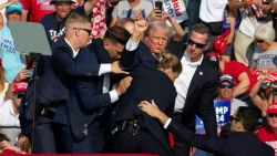 Republican candidate Donald Trump is seen with blood on his face surrounded by secret service agents as he is taken off the stage at a campaign event at Butler Farm Show Inc. in Butler, Pennsylvania, July 13, 2024. Republican candidate Donald Trump was evacuated from the stage at today's rally after what sounded like shots rang out at the event in Pennsylvania, according to AFP.
The former US president was seen with blood on his right ear as he was surrounded by security agents, who hustled him off the stage as he pumped his first to the crowd.
Trump was bundled into an SUV and driven away. (Photo by Rebecca DROKE / AFP) (Photo by REBECCA DROKE/AFP via Getty Images)