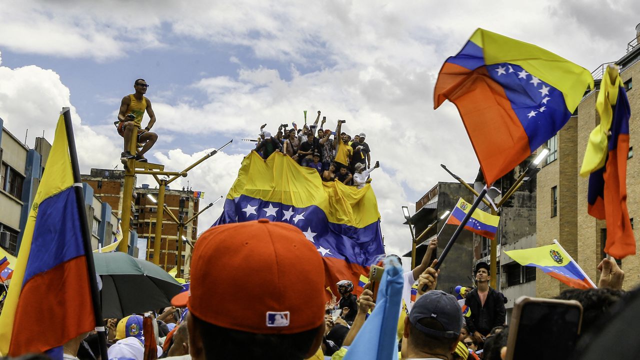 TOPSHOT - Supporters of Venezuelan opposition leader Maria Corina Machado and Venezuelan presidential candidate Edmundo Gonzalez attend a campaign rally in Valencia, Carabobo state, Venezuela on July 13, 2024. (Photo by Juan Carlos HERNANDEZ / AFP) (Photo by JUAN CARLOS HERNANDEZ/AFP via Getty Images)