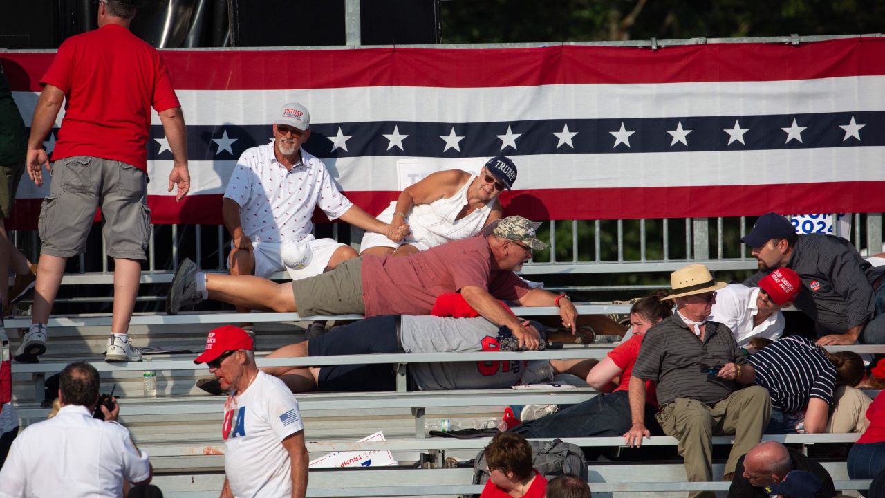 Trump ers are seen laying in the stands after guns were fired at Republican candidate Donald Trump at a campaign event at Butler Farm Show Inc. in Butler, Pennsylvania, July 13, 2024. Republican candidate Donald Trump was evacuated from the stage at today's rally after what sounded like shots rang out at the event in Pennsylvania, according to AFP.
The former US president was seen with blood on his right ear as he was surrounded by security agents, who hustled him off the stage as he pumped his first to the crowd.
Trump was bundled into an SUV and driven away. (Photo by Rebecca DROKE / AFP) (Photo by REBECCA DROKE/AFP via Getty Images)