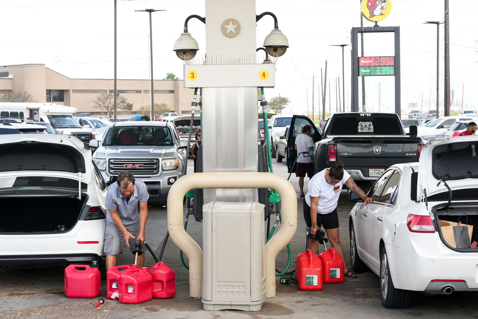 People fill gas cans in Freeport, Texas, on Tuesday.