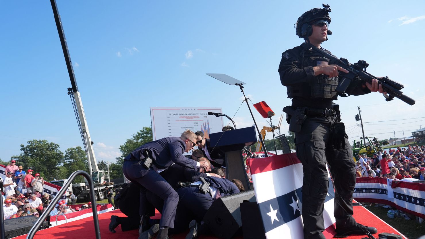 Secret Service agents cover former president Donald Trump during a campaign rally for former President Donald Trump at Butler Farm Show Inc. on Saturday, July 13, 2024 in Butler, Pa.