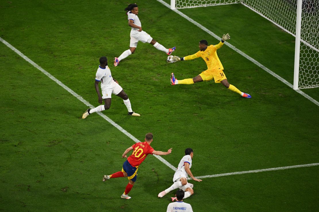 Dani Olmo fires his goal in off Jules Koundé.