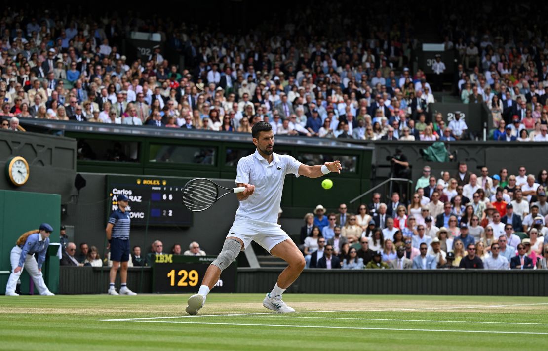 Djokovic returns against Alcaraz.