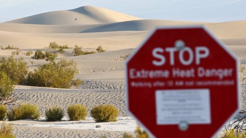 A 'Stop Extreme Heat Danger' sign stands at Mesquite Flat Sand Dunes during a long-duration heat wave which is impacting much of California on July 9, 2024 in Death Valley National Park, California.