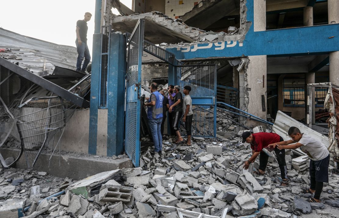 DEIR AL BALAH, GAZA - JULY 15: Palestinians and UN workers examine the destroyed makeshift tents and shelters after Israeli attack hits a United Nations Relief and Works Agency for Palestine Refugees in the Near East (UNRWA) school, killing and injuring many in Nuseirat Refugee Camp of Deir al-Balah, Gaza on July 15, 2024. (Photo by Abed Rahim Khatib/Anadolu via Getty Images)