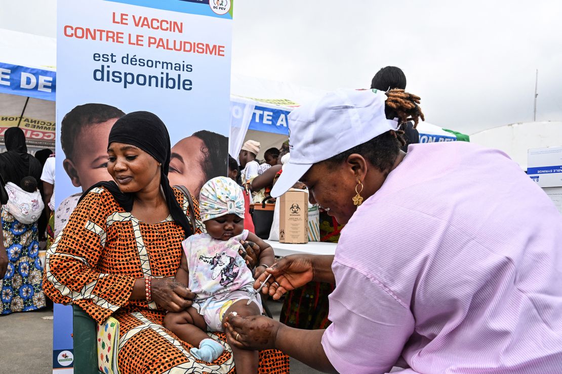 Health workers vaccinate babies against malaria during a vaccination campaign in a commune in Abidjan, West Africa, in 2024.