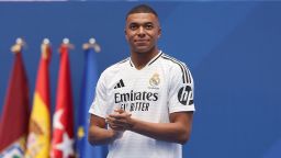 TOPSHOT - French forward Kylian Mbappe looks on during a first appearance as a Real Madrid player before fans at the Santiago Bernabeu Stadium in Madrid on July 16, 2024, after signing his new five-season contract. Still celebrating Spain's Euro 2024 triumph, Real Madrid fans have even more to cheer this July 16, 2024, as French superstar Kylian Mbappe is officially presented to a packed-out Santiago Bernabeu stadium. (Photo by Pierre-Philippe MARCOU / AFP) (Photo by PIERRE-PHILIPPE MARCOU/AFP via Getty Images)