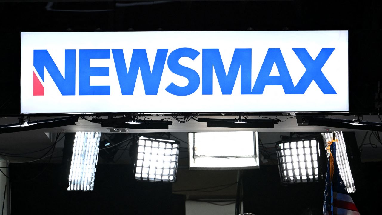 News anchors work at Newsmax's booth during the second day of the 2024 Republican National Convention in Milwaukee.