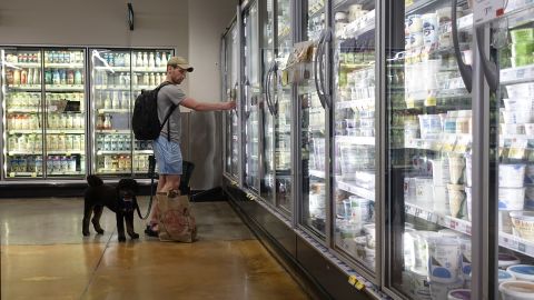 A customer shops for dairy products at a supermarket.