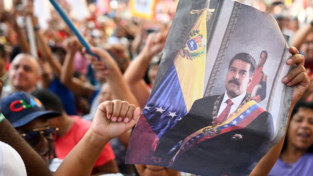 A supporter holds a picture of Venezuelan President and presidential candidate Nicolas Maduro during a rally in Caracas on July 16, 2024. Venezuela will hold presidential elections on July 28. (Photo by Federico PARRA / AFP) (Photo by FEDERICO PARRA/AFP via Getty Images)