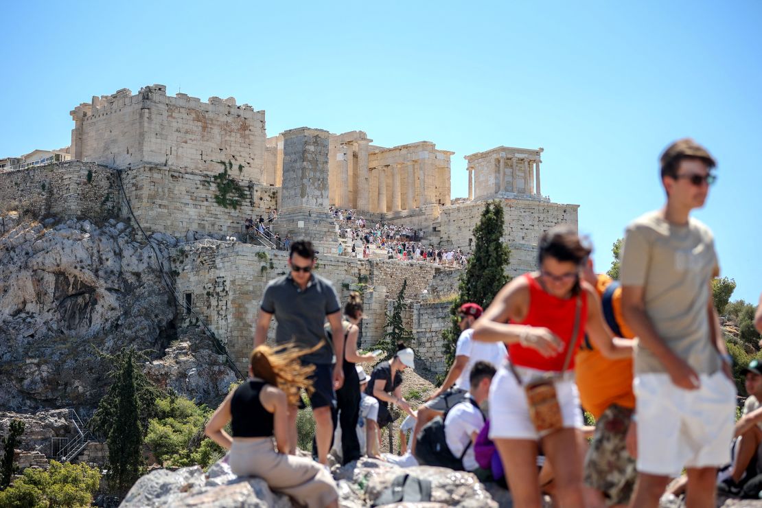 Tourists leave the Acropolis hill in Athens, on July 17, 2024. The site was shut at 12 p.m. for five hours to keep visitors out of the heat.