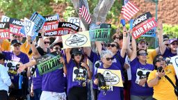 Disney employees rally outside the main entrance of Disneyland Resort in Anaheim, California, on July 17, 2024, ahead of a planned strike authorization vote. More than 200 Disneyland Resort employees protested outside the world-famous California theme parks July 17, calling for better wages and denouncing alleged anti-union practices by the company ahead of a looming strike vote. Featuring workers in costumes from the parks' "Indiana Jones" and "Star Wars" themed rides, among others, the rally was organized by unions representing some 14,000 Disneyland employees, from rollercoaster operators to candy makers.