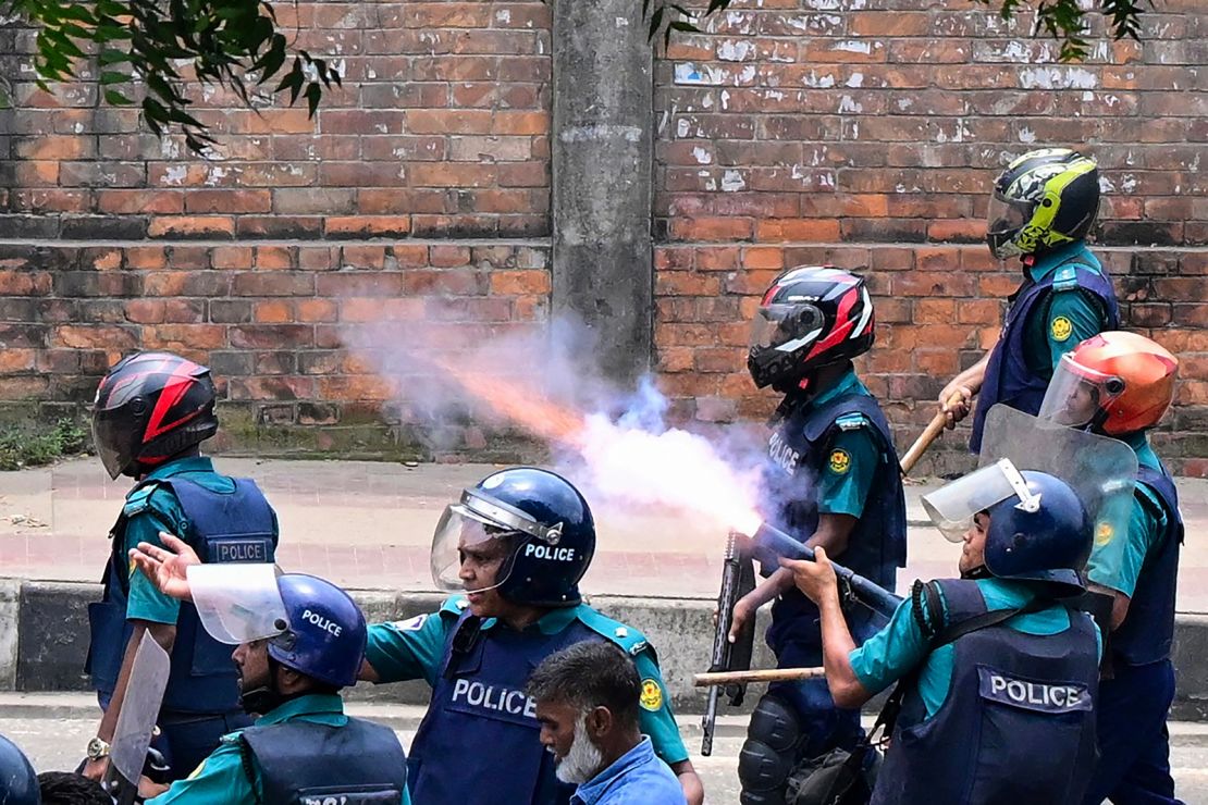 Bangladeshi police fire tear gas to disperse protesters during a clash in Dhaka on July 18, 2024.