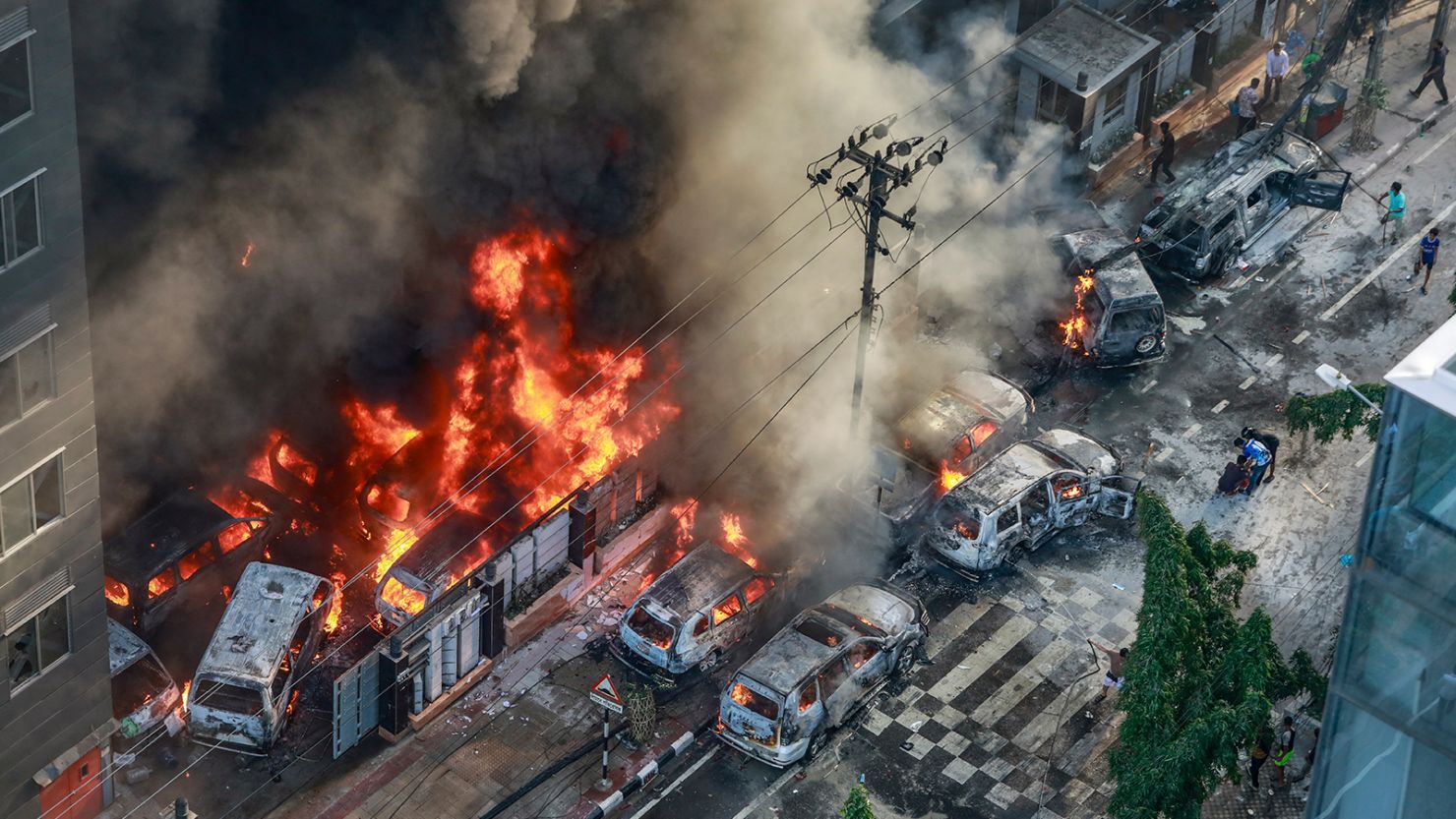 Smoke rises from burning vehicles after protesters set them on fire during anti-quota protests in Dhaka, Bangladesh on July 18, 2024.